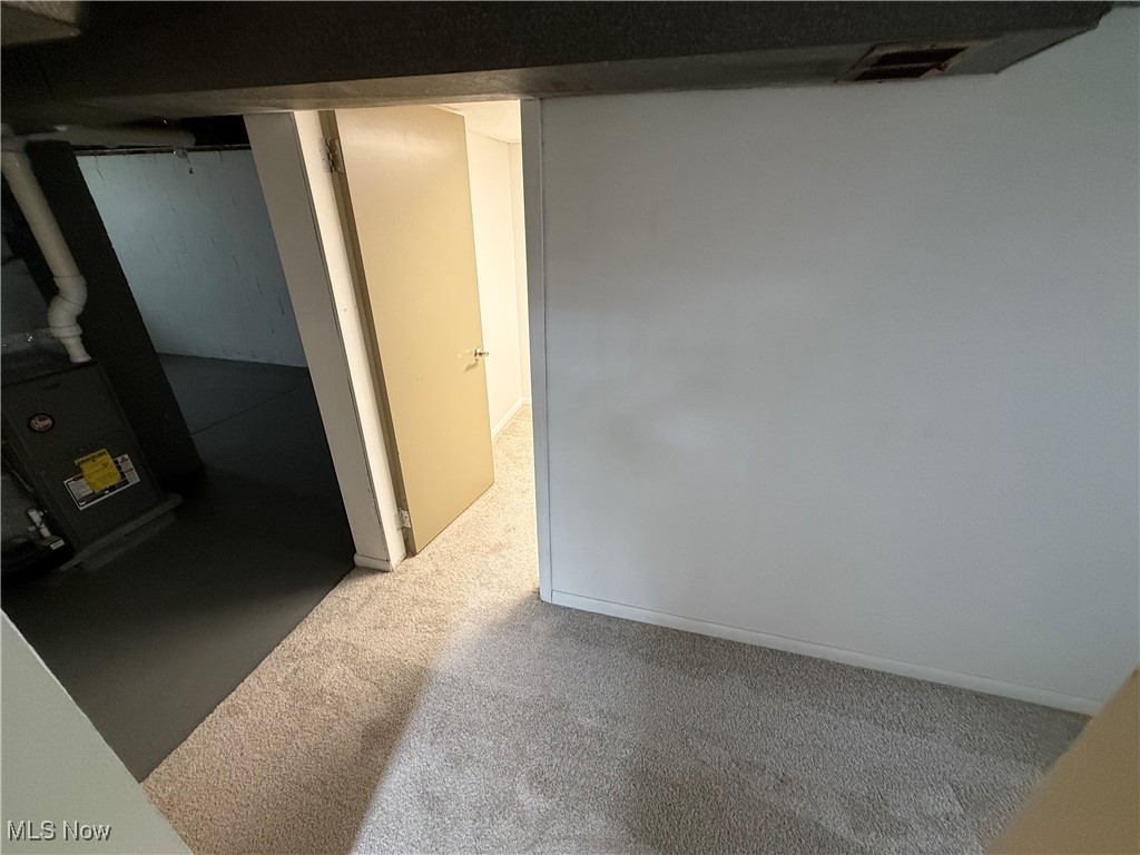 9417 Alexander Road Garfield Heights, OH 44125 - Photo 32 of 38 Finished basement with visible vents and carpet