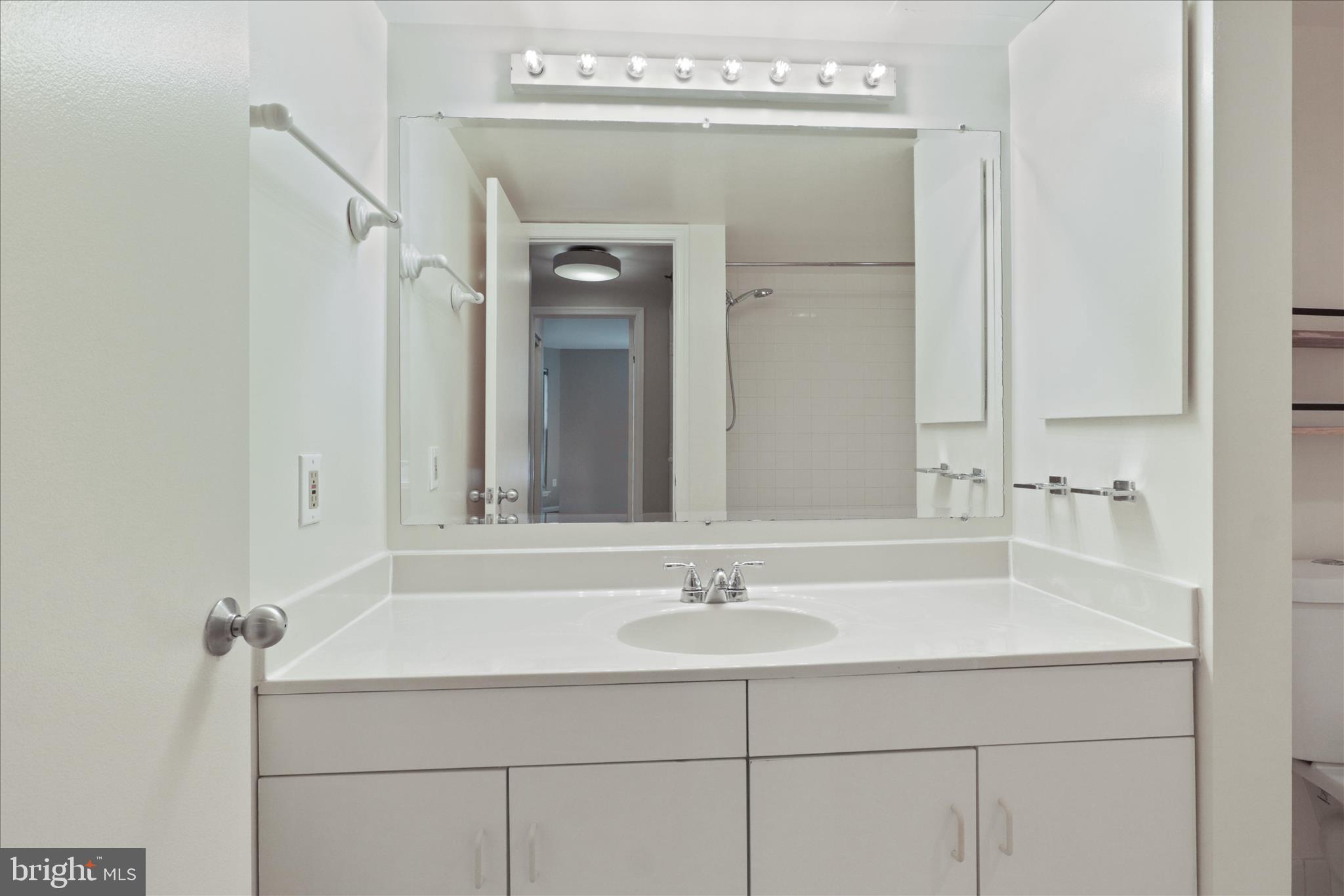 1230 23rd Street Northwest, Unit 918 Washington, DC 20037 - Photo 13 of 30 a bathroom with a sink and a mirror