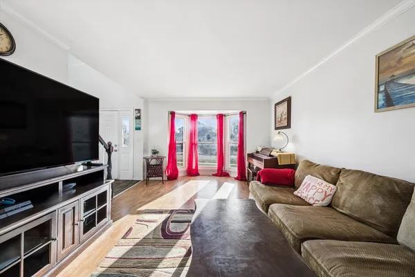 a view of a dining room with furniture wooden floor and chandelier