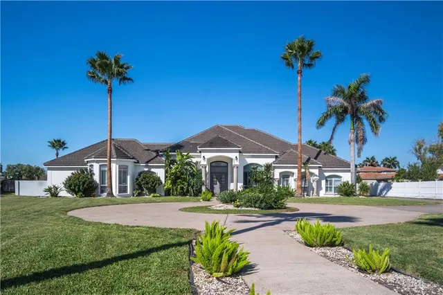 a front view of a house with yard and green space