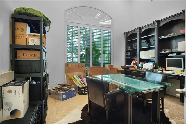 a view of a patio with table and chairs and potted plants with wooden fence