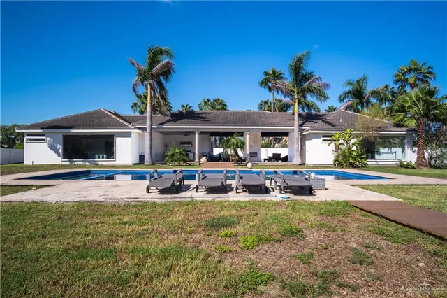 a view of house and yard with swimming pool