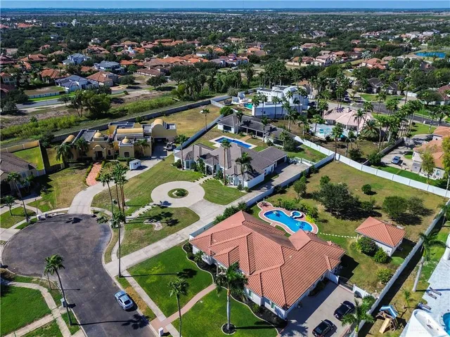 an aerial view of residential houses with outdoor space and swimming pool