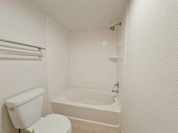 a bathroom with a toilet and a bathtub