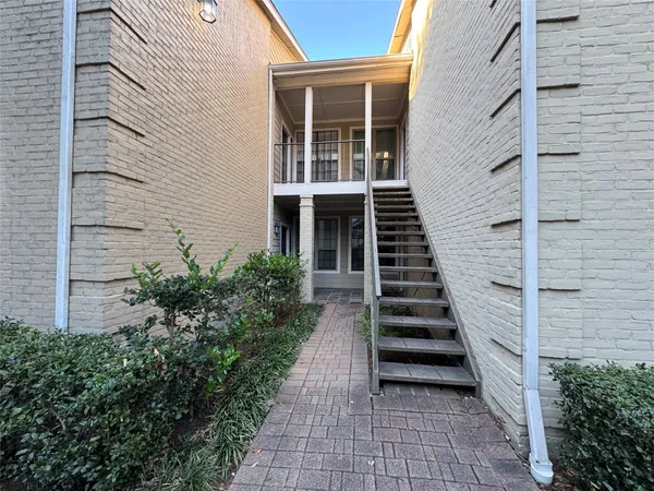 a view of a entryway with flower plants