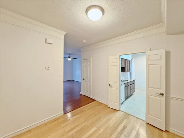 a view of a hallway with wooden floor