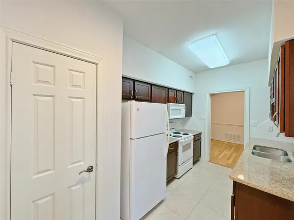 a white refrigerator freezer sitting inside of a kitchen