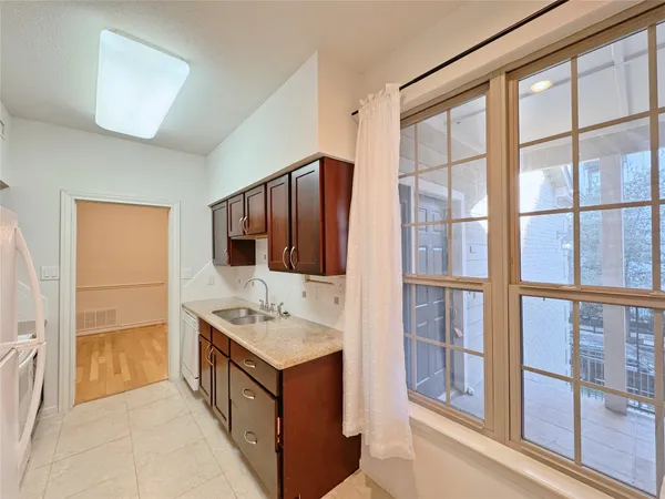 a bathroom with a granite countertop sink and a large mirror