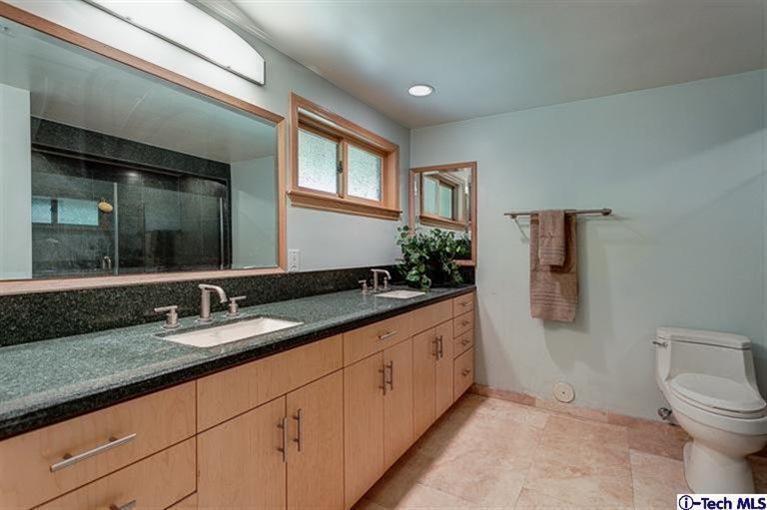 2238 Rim Road Bradbury, CA 91008 - Photo 15 of 27 a bathroom with double sink and a mirror