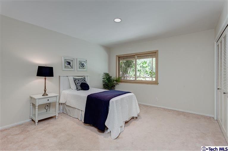 2238 Rim Road Bradbury, CA 91008 - Photo 17 of 27 a spacious bedroom with a bed and a lamp