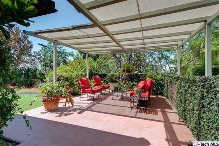 2238 Rim Road Bradbury, CA 91008 - Photo 20 of 27 a view of a patio with table and chairs potted plants with wooden floor