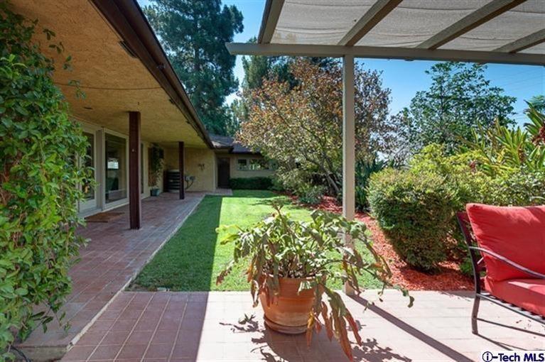 2238 Rim Road Bradbury, CA 91008 - Photo 21 of 27 a view of a patio with table and chairs potted plants