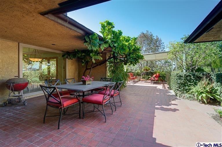 2238 Rim Road Bradbury, CA 91008 - Photo 23 of 27 a patio with table and chairs and potted plants