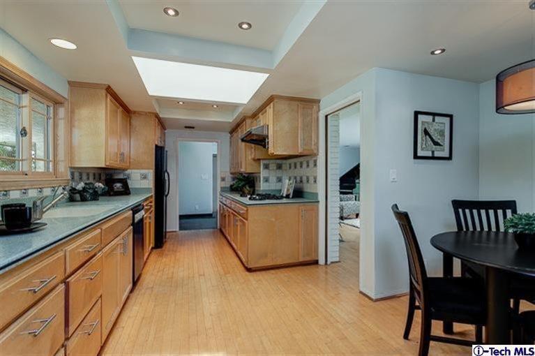 2238 Rim Road Bradbury, CA 91008 - Photo 10 of 27 a large kitchen with stainless steel appliances granite countertop a stove a sink a dining table and chairs