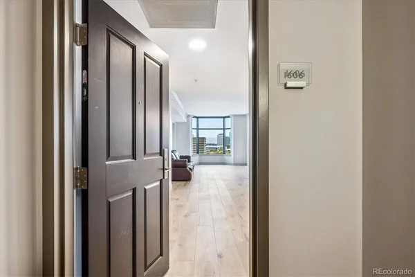 a view of a hallway with living room and utility room