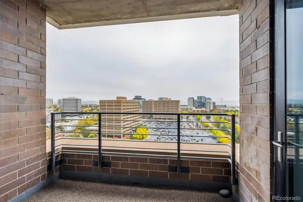 a bathroom with a granite countertop sink a toilet and a mirror