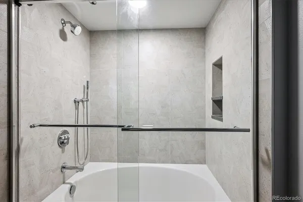 a bathroom with a granite countertop sink and white cabinets