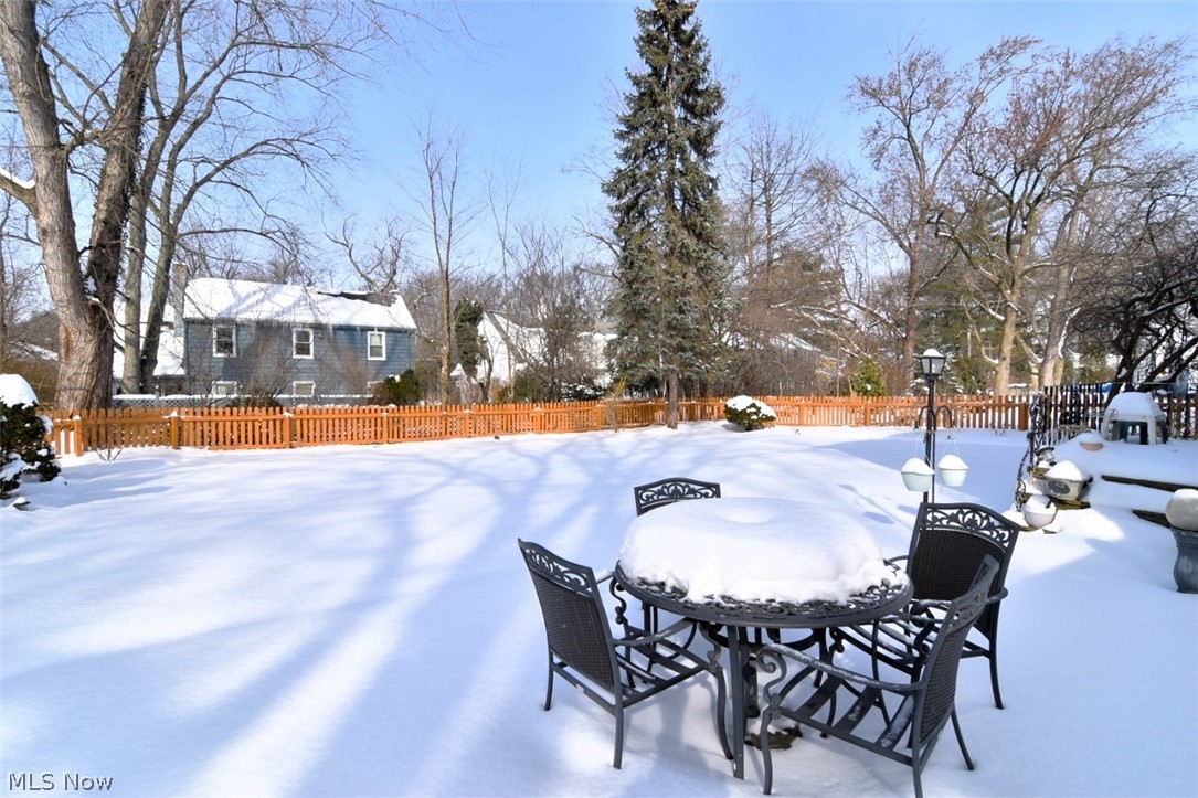 15991 Henley Road Cleveland, OH 44112 - Photo 34 of 36 Snowy yard with a fenced backyard and outdoor dining space