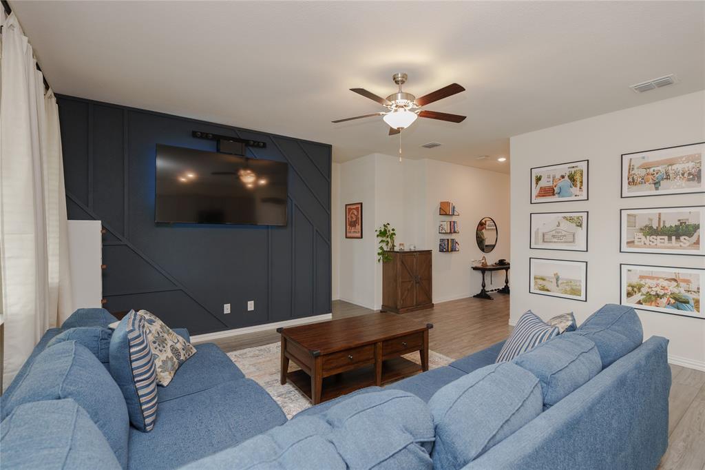 677 Ridgeback Trail Fort Worth, TX 76052 - Photo 13 of 40 a living room with furniture and a flat screen tv