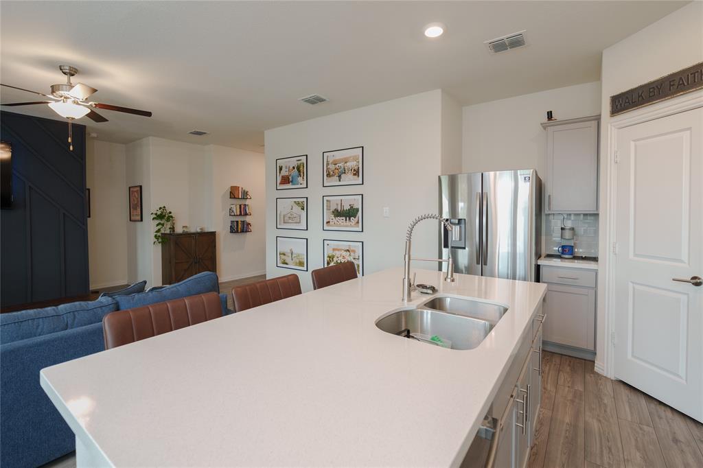 677 Ridgeback Trail Fort Worth, TX 76052 - Photo 40 of 40 a kitchen with stainless steel appliances a sink stove and refrigerator