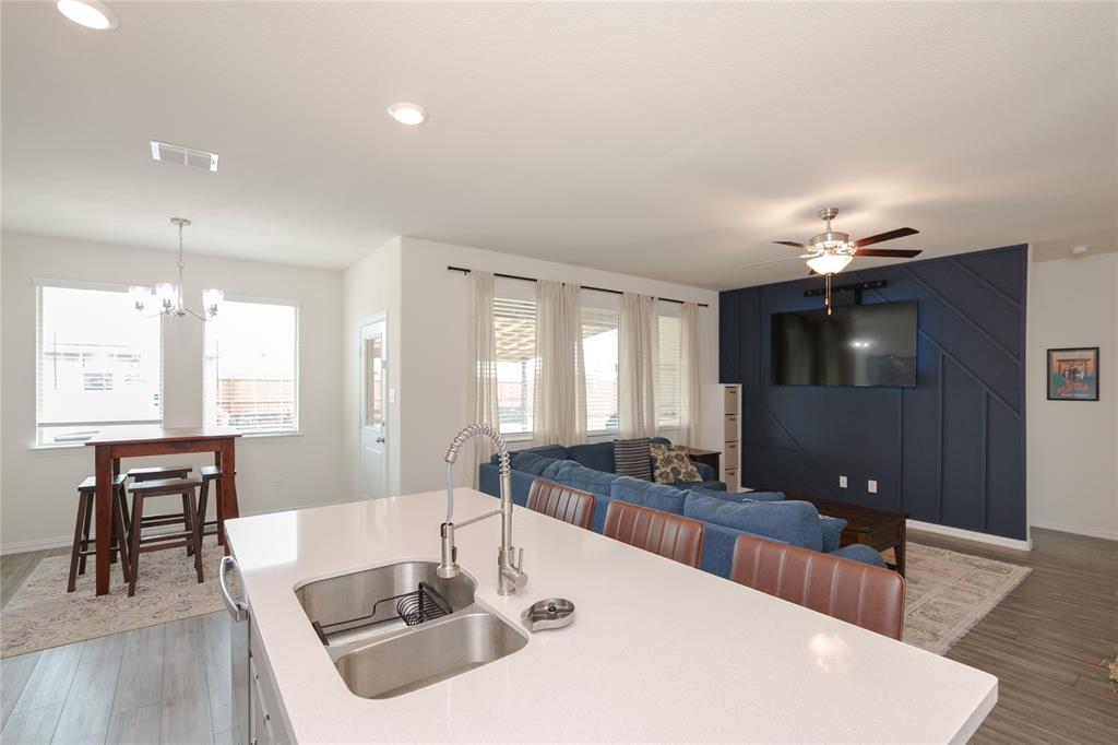677 Ridgeback Trail Fort Worth, TX 76052 - Photo 20 of 40 a kitchen with a dining table chairs and granite counter tops
