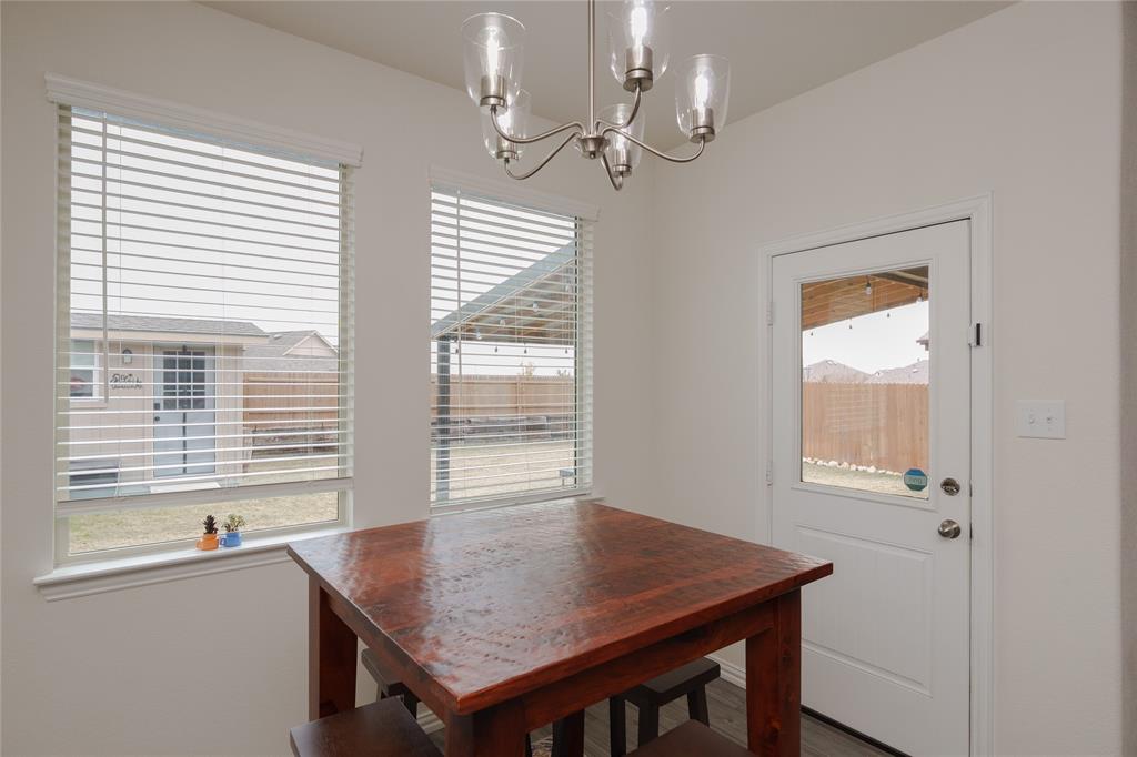 677 Ridgeback Trail Fort Worth, TX 76052 - Photo 21 of 40 a view of a dining room with a table and chairs