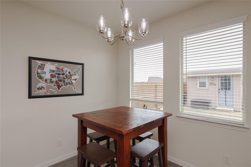 677 Ridgeback Trail Fort Worth, TX 76052 - Photo 22 of 40 a view of a dining room with furniture window and wooden floor