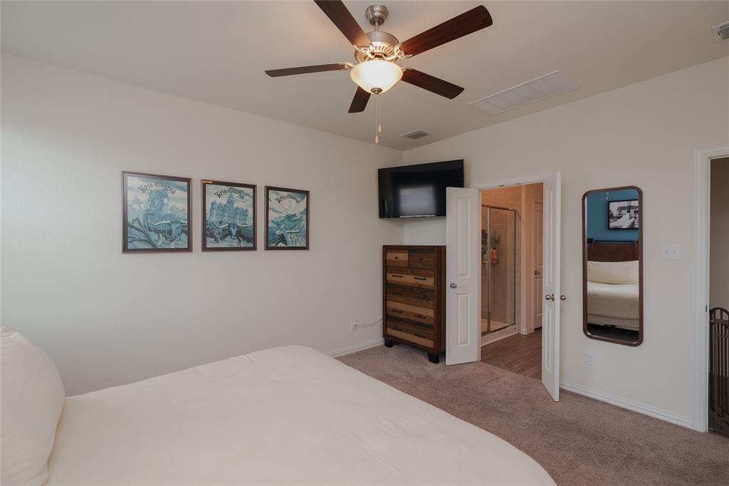 677 Ridgeback Trail Fort Worth, TX 76052 - Photo 24 of 40 a bedroom with a bed and a ceiling fan