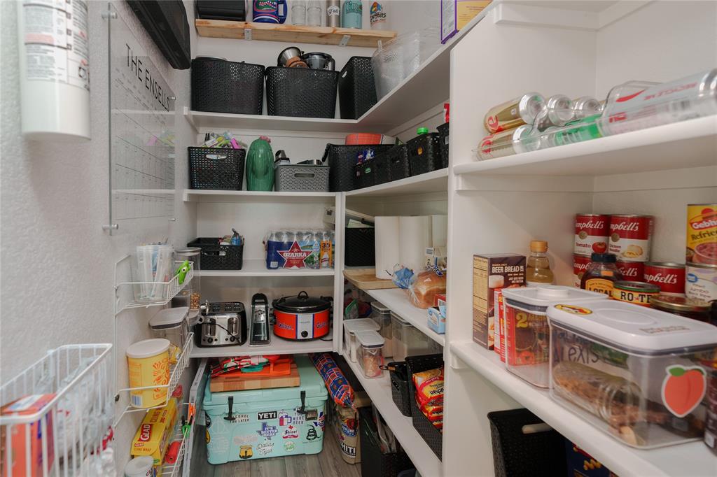 677 Ridgeback Trail Fort Worth, TX 76052 - Photo 30 of 40 a utility room with stainless steel appliances and a wooden floor