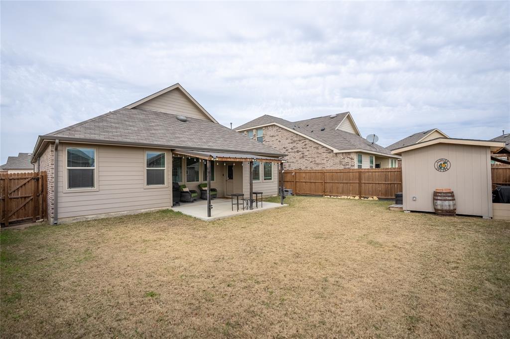 677 Ridgeback Trail Fort Worth, TX 76052 - Photo 36 of 40 a view of a house with a yard and large tree