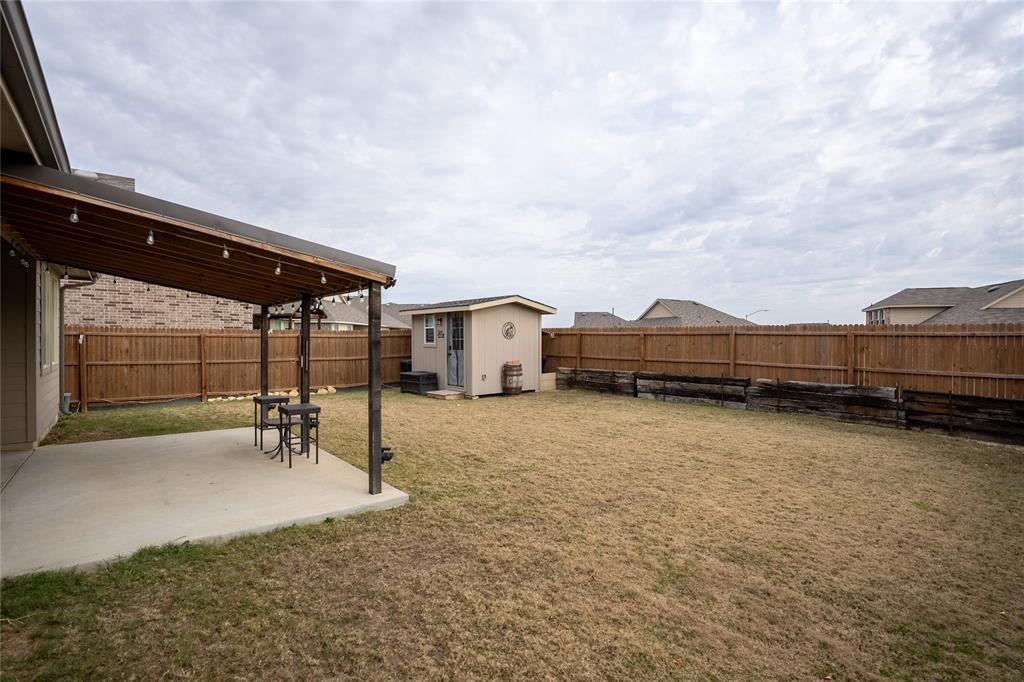 677 Ridgeback Trail Fort Worth, TX 76052 - Photo 37 of 40 a backyard of a house with table and chairs