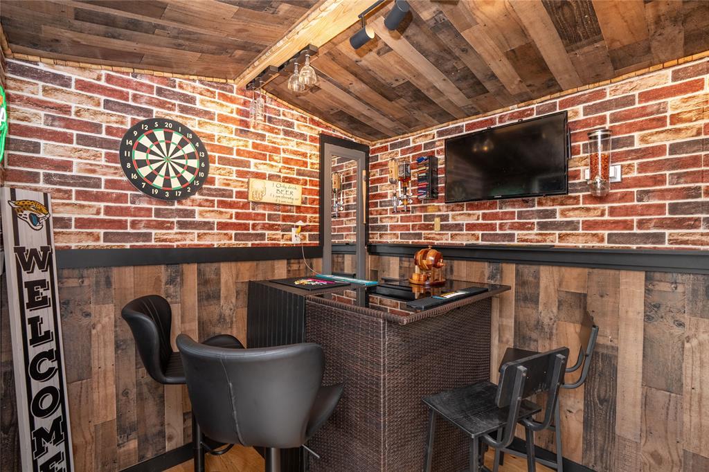 677 Ridgeback Trail Fort Worth, TX 76052 - Photo 38 of 40 a kitchen with a table chairs and a microwave