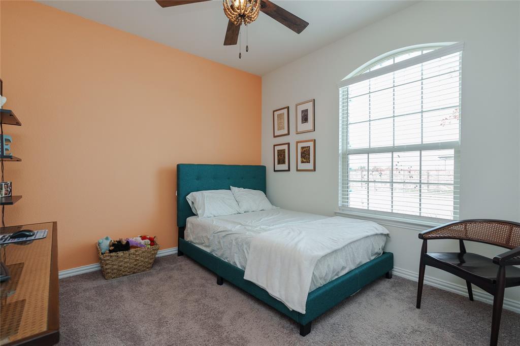 677 Ridgeback Trail Fort Worth, TX 76052 - Photo 7 of 40 a bedroom with a bed and a window