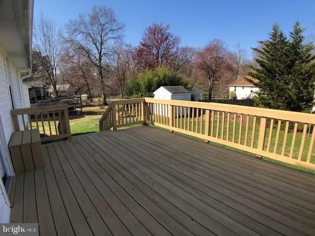 a view of balcony with wooden floor and fence