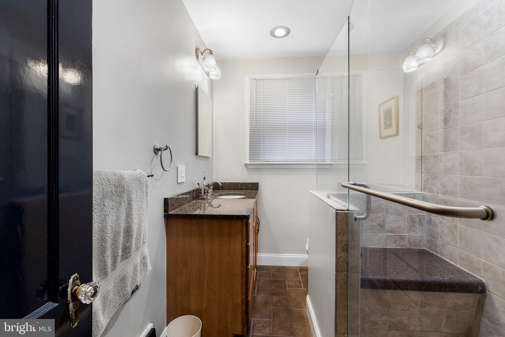 765 Dividing Road Severna Park, MD 21146 - Photo 9 of 17 a bathroom with a sink a toilet and shower