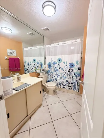 a bathroom with a sink mirror toilet and shower