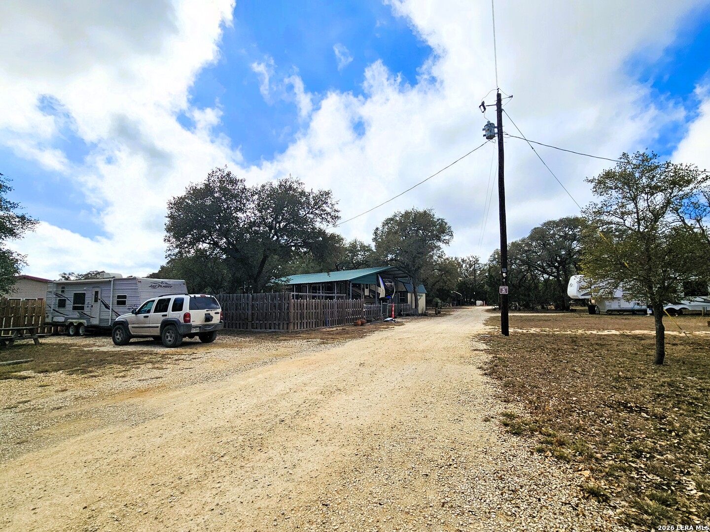 605 Lakeshore Lane Bandera, TX 78003 - Photo 11 of 32 a view of a yard with cars