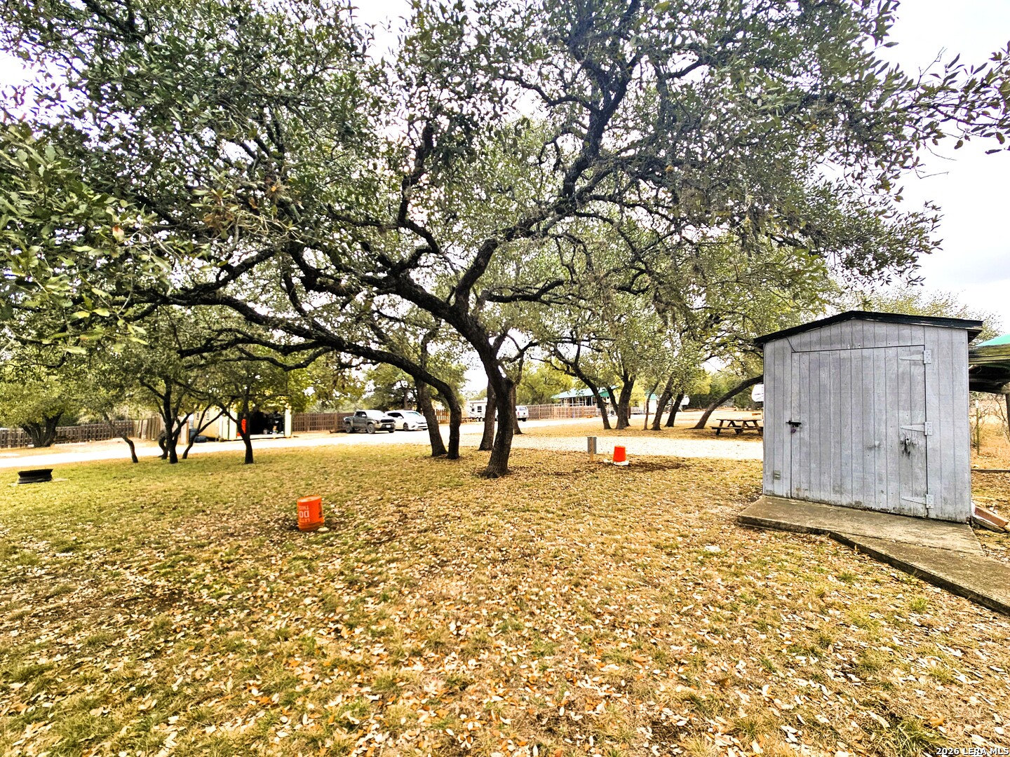 605 Lakeshore Lane Bandera, TX 78003 - Photo 13 of 32 a street view with large trees