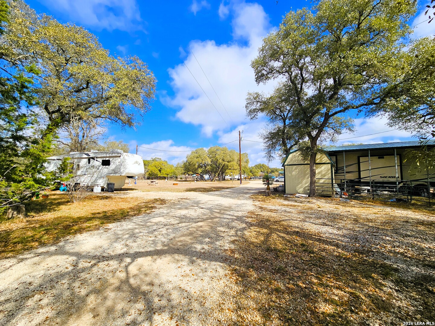 605 Lakeshore Lane Bandera, TX 78003 - Photo 26 of 32 a view of a yard with a tree