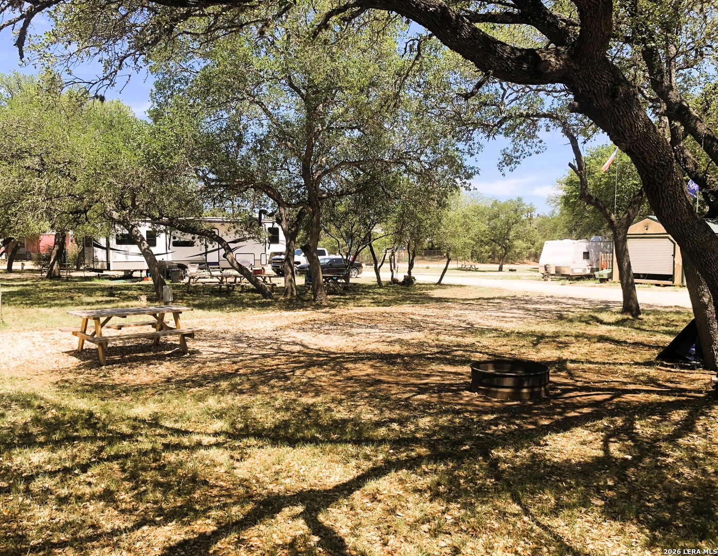 605 Lakeshore Lane Bandera, TX 78003 - Photo 31 of 32 a view of a yard with a tree