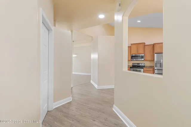a view of a hallway with wooden floor