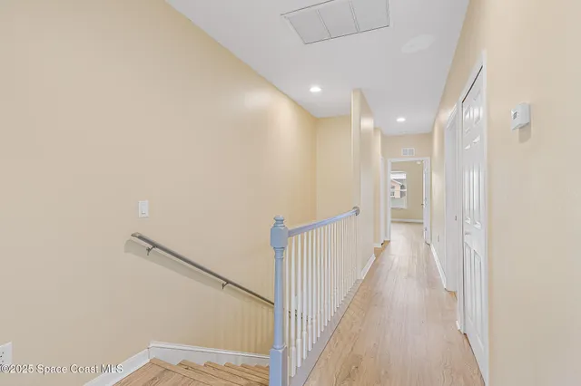 an aerial view of residential houses with outdoor space and lake view