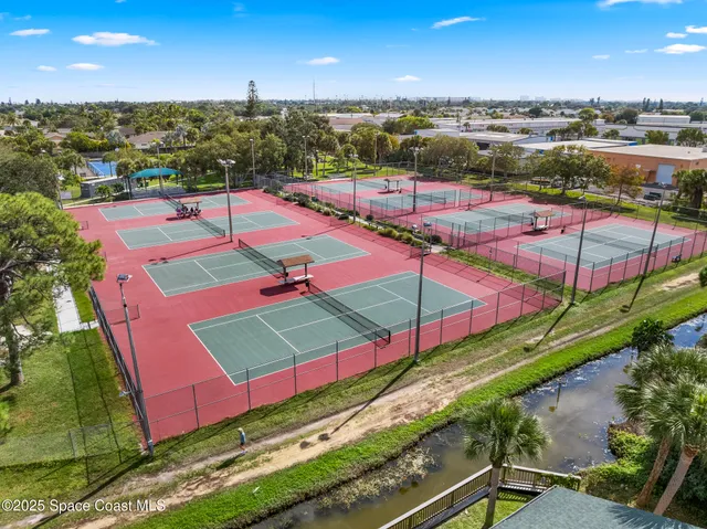 a view of a deck with a big yard and potted plants