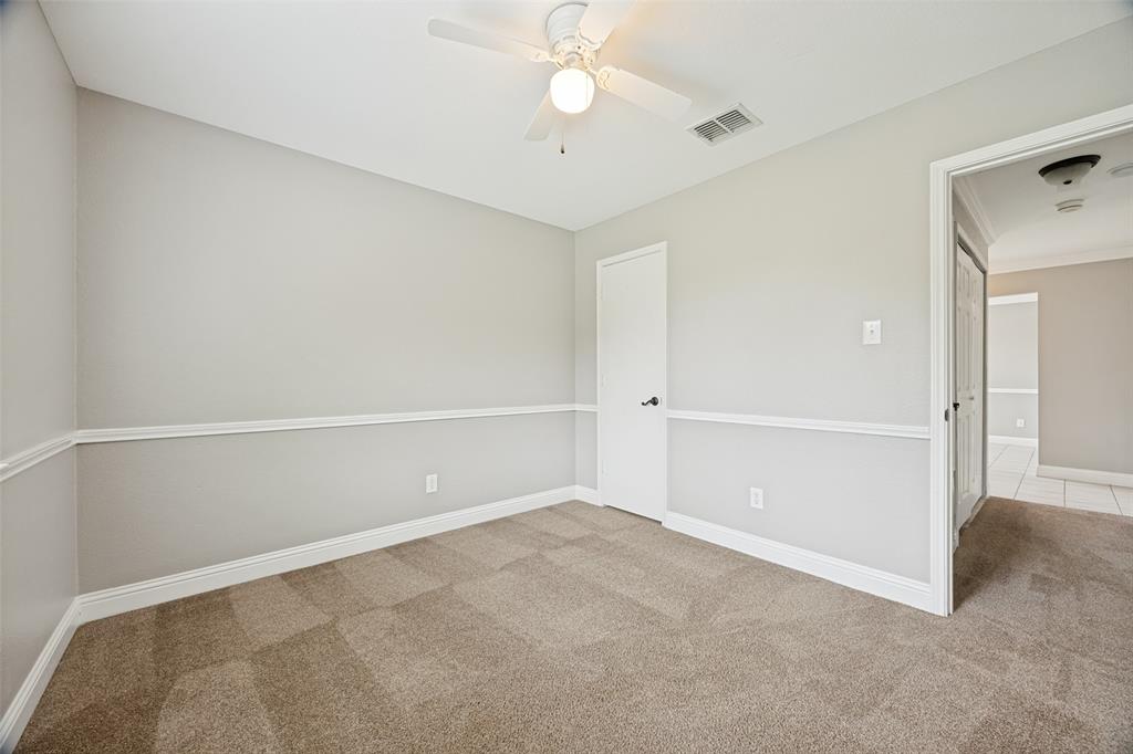 1601 Elm Street Anna, TX 75409 - Photo 19 of 25 an empty room with closet and a chandelier fan