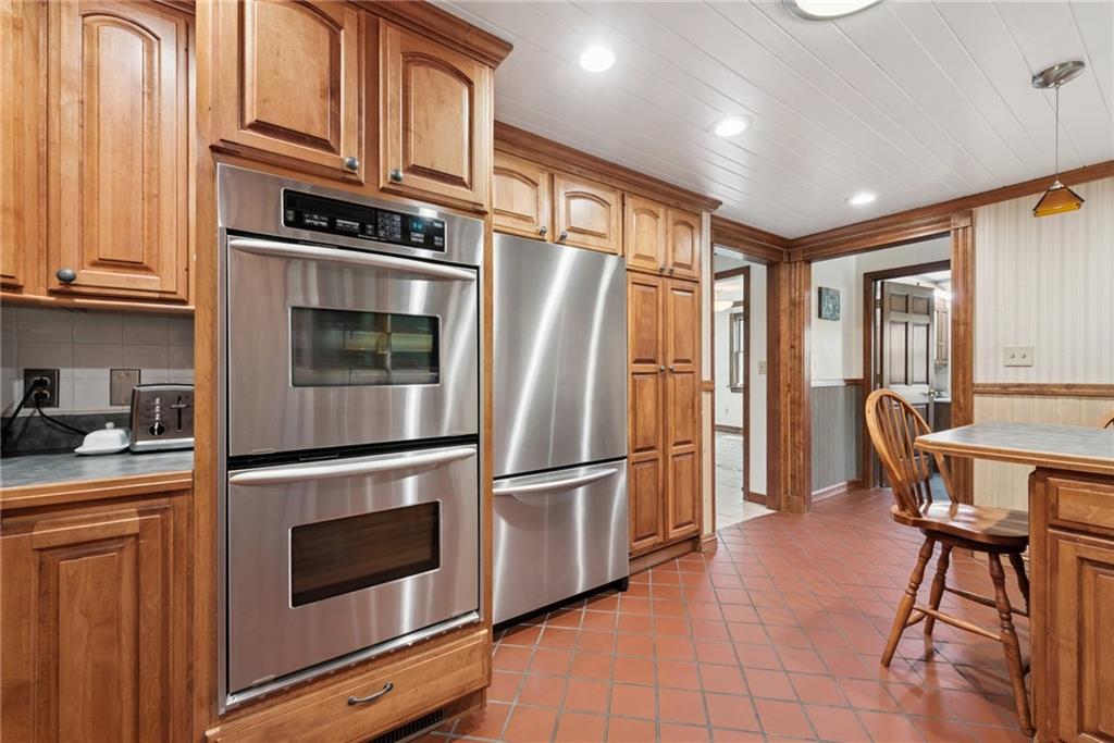 114 Gardner Road Dawson, PA 15428 - Photo 8 of 49 a kitchen with stainless steel appliances granite countertop a refrigerator microwave and stove top oven