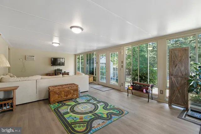 a living room with furniture and a floor to ceiling window