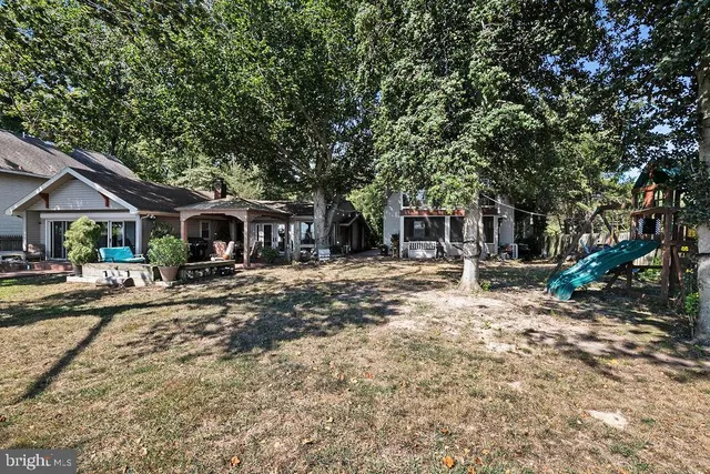 a view of a field of grass and trees