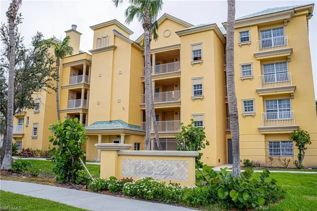 a front view of a residential apartment building with a yard