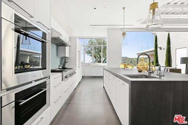 a kitchen with a sink stove and microwave