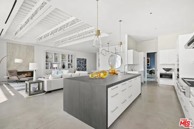 a kitchen that has a lot of cabinets and wooden floor